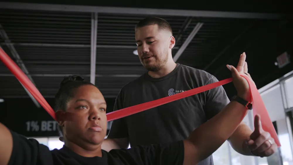 A clinician watching a patient's overhead band movement
