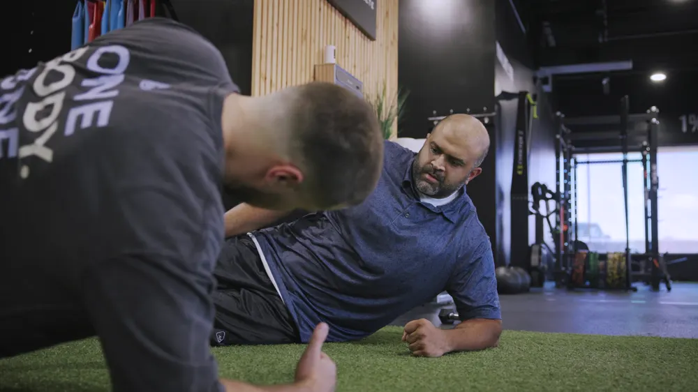 Movement-based work on the floor of the Identity gym